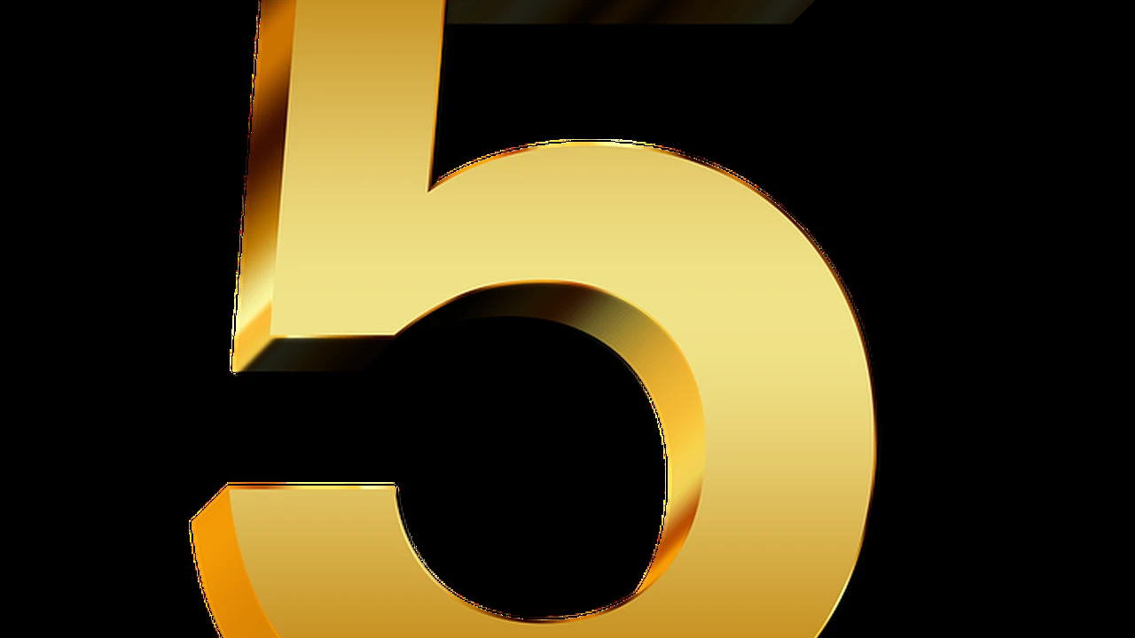 Two mint chocolate milkshakes with whipped cream and green sprinkles.