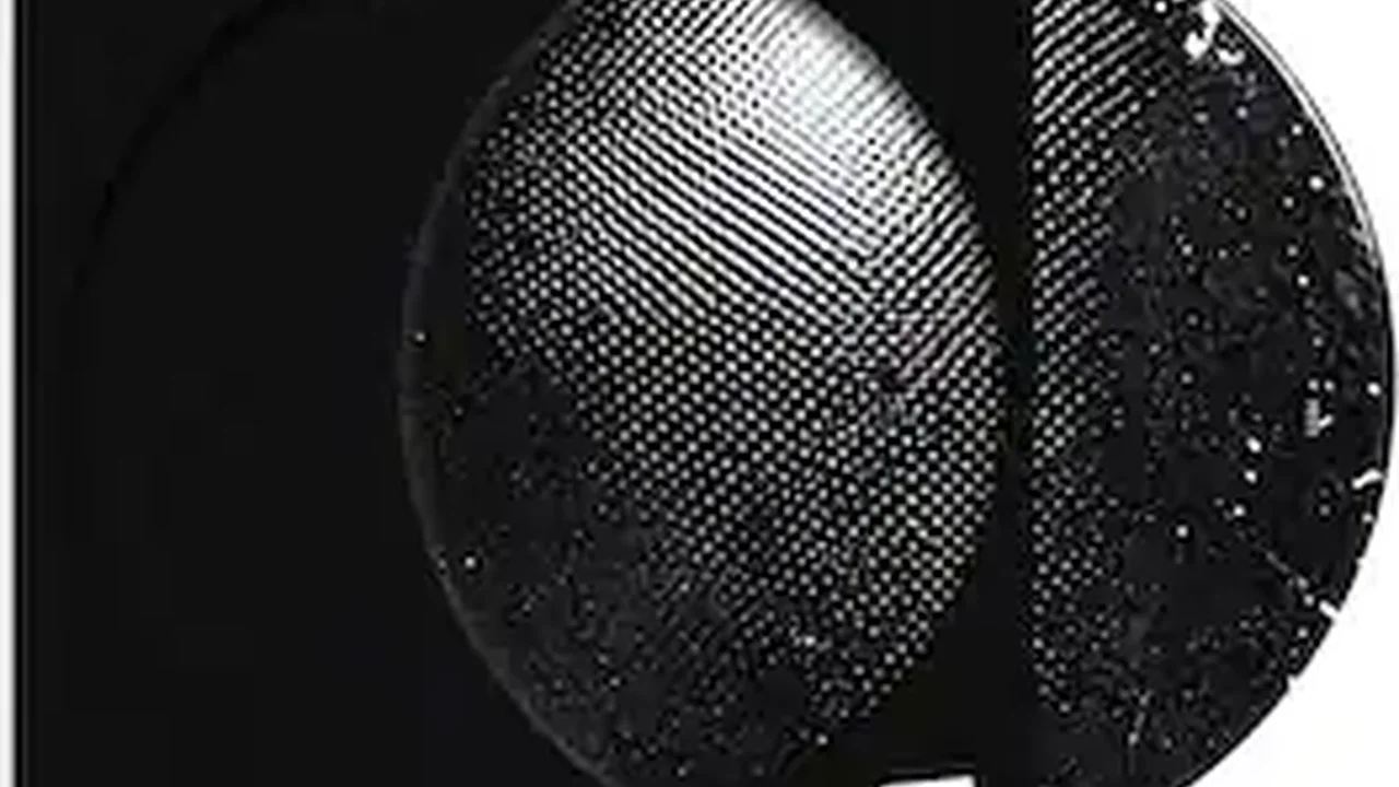 Close up on a plate of mashed potatoes, topped with baked pork chops with cream of mushroom soup, and a side of green beans.