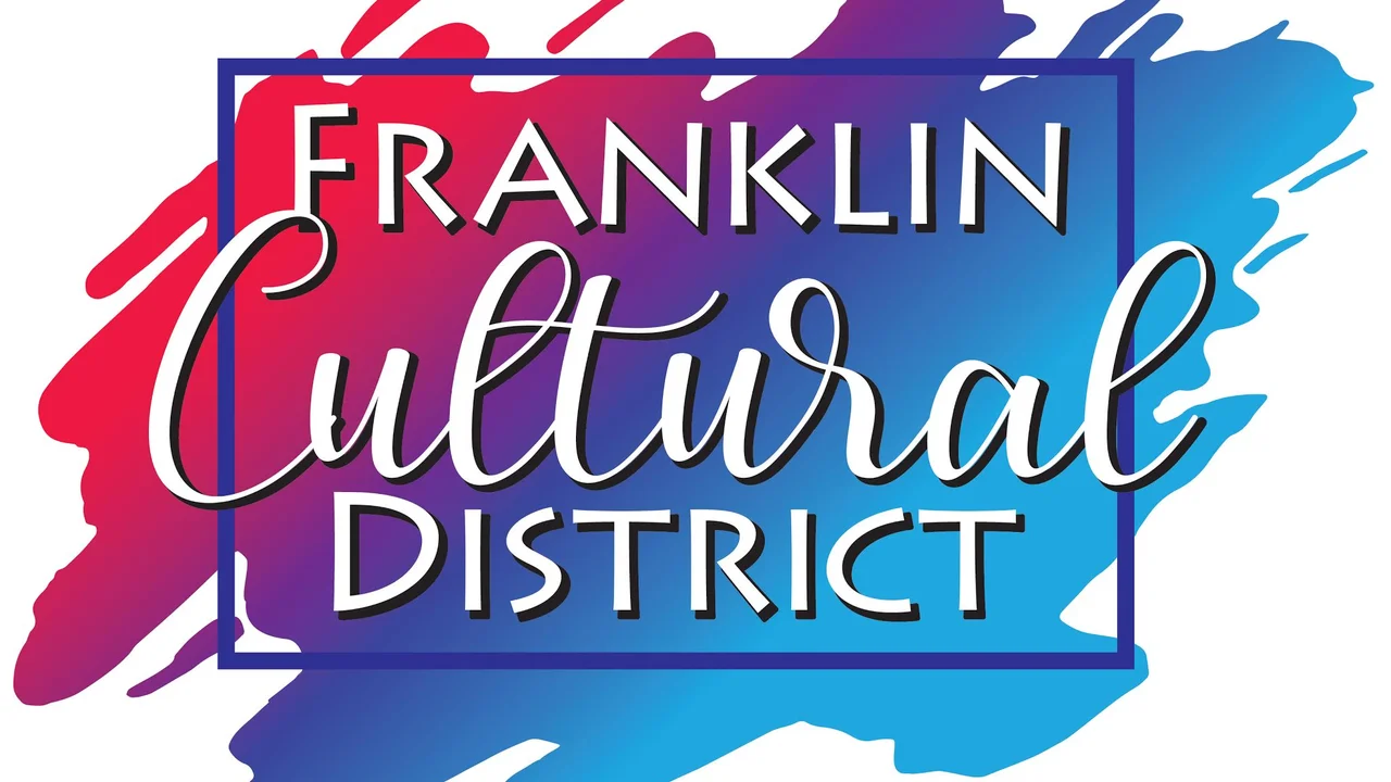 blue bowl of black bean beef tortilla soup on a board with cilantro and shredded cheese in background