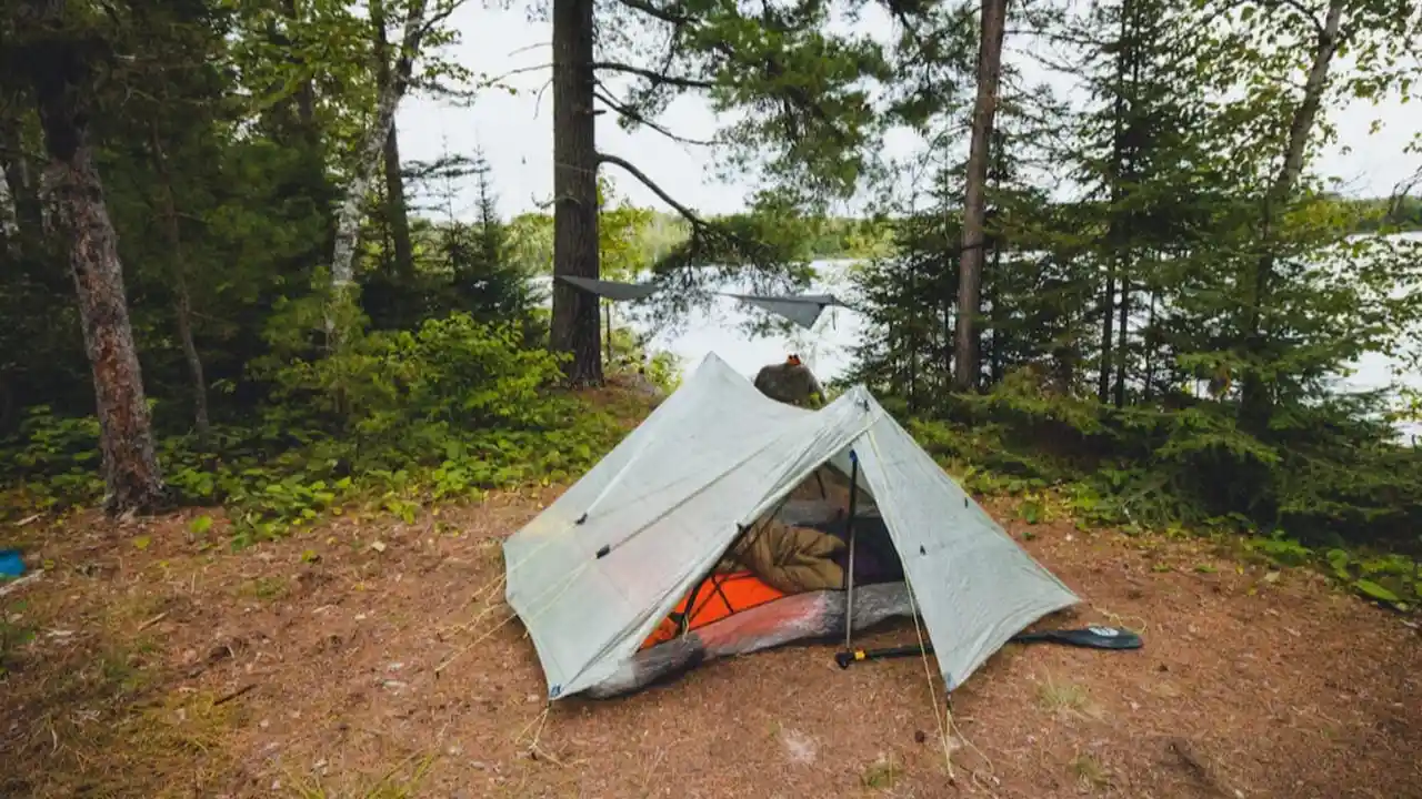 Close up on a plate of mashed potatoes, topped with baked pork chops with cream of mushroom soup, and a side of green beans.