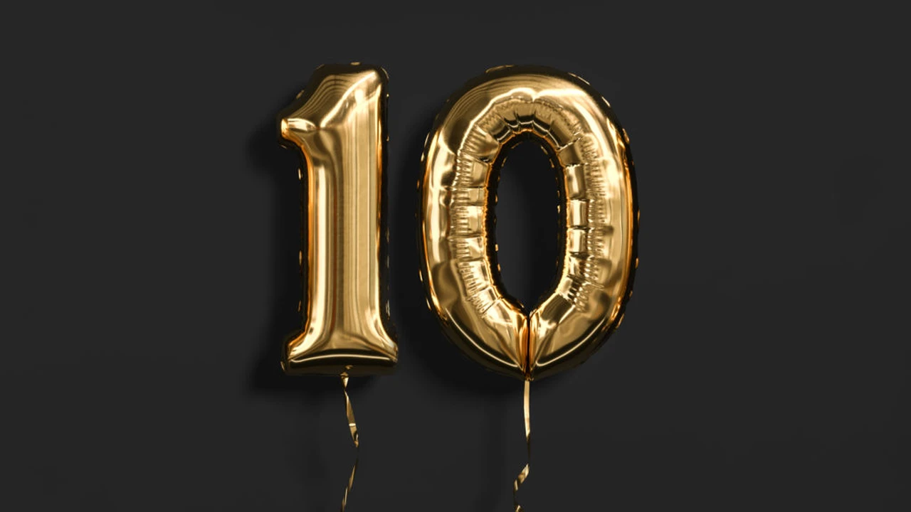 blue bowl of black bean beef tortilla soup on a board with cilantro and shredded cheese in background