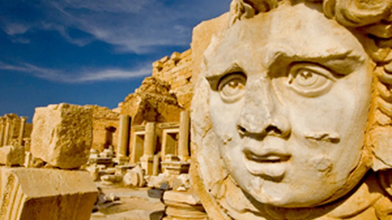 blue bowl of black bean beef tortilla soup on a board with cilantro and shredded cheese in background